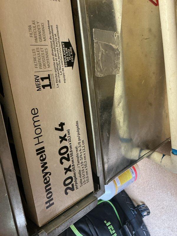 Performed a heating system maintenance visit under an expired-but-owed service plan, inspecting the wall-mounted digital thermostat (reading 69°F) and the air handler/ductwork in the utility closet. A 20x20x4 MERV 11 pleated filter was on site for the system but was not included in the scope of the visit, and the filter's airflow arrow should be matched to the air handler's direction when it is installed.