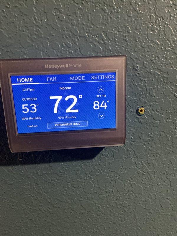 Performed seasonal heating maintenance on two systems, inspecting air handler cabinets, control board wiring terminations, and evaporator coil assemblies, and replacing the 20x22x1 air filters per the monthly service plan. Verified thermostat operation in heat mode, with the system calling for heat and the indoor temperature stable at 72°F. Noted a permanent hold setting at 84°F on the thermostat and light dust accumulation inside the air handler cabinet.