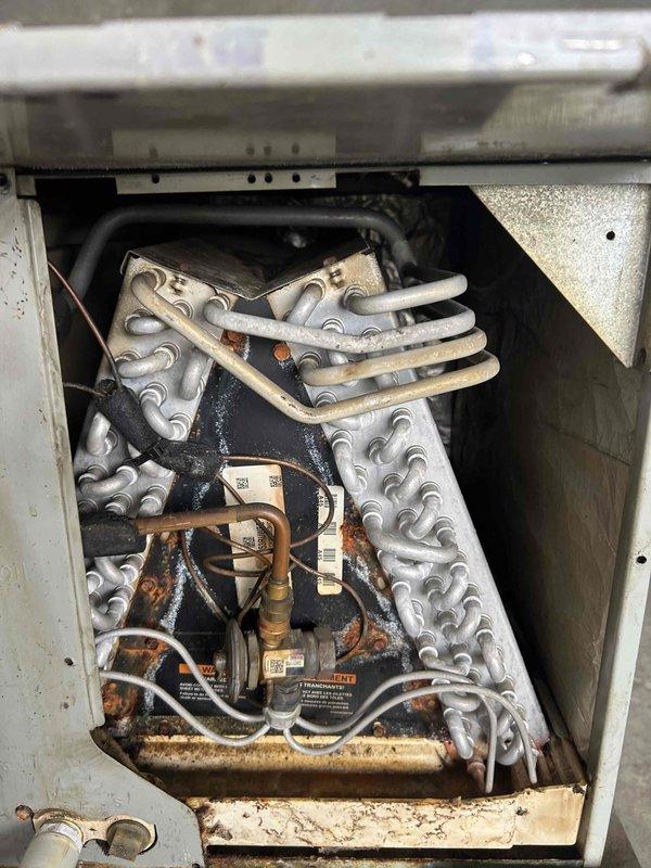 Performed heating maintenance on the furnace, including a combustion analysis with a calibrated analyzer to verify safe and efficient operation. Inspected the AC evaporator coil and air handler cabinet, confirming the prior diagnosis and documenting heavy rust and corrosion on the coil assembly, center divider, and drain pan; repair options and estimates were prepared for customer review.