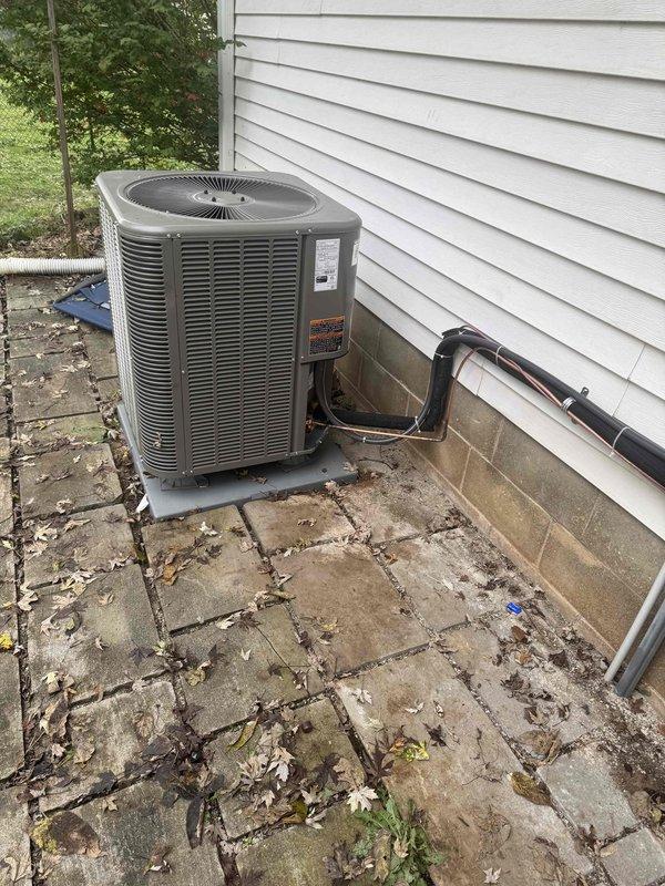 Completed a full Lennox heat pump system installation, including setting the outdoor condenser unit on a level pad and routing insulated refrigerant lines and electrical conduit along the foundation wall with secured clips. Installed a Dwyer Magnehelic differential pressure gauge on the indoor air handling equipment to monitor static pressure and verify airflow performance, with the reading within the normal low-range operating scale at startup.