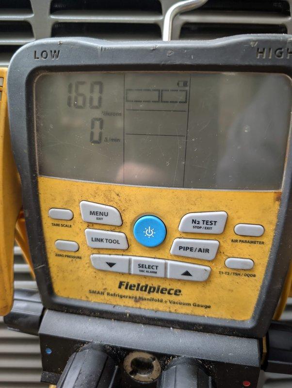 Installed a complete Lennox heat pump system for a mobile home, setting the outdoor condenser unit on a level pad with a properly mounted electrical disconnect and conduit. The refrigerant circuit was evacuated with a digital micron gauge to 160 microns with no rise, confirming a dry, leak-free system before charging and commissioning.