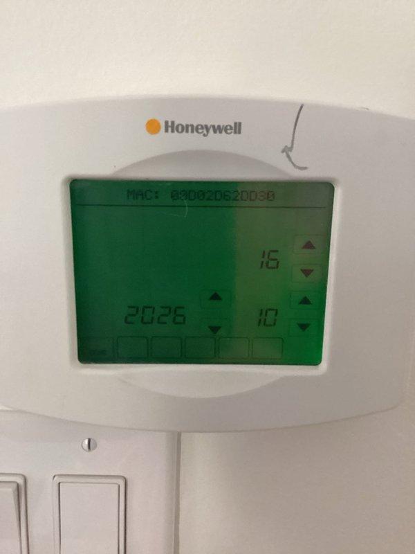Responded to an emergency call for an unresponsive thermostat on a 7-year-old heat pump system and replaced the failed Honeywell wall-mounted digital thermostat. Verified the new unit powered up and completed its date/time configuration, and inspected the indoor air handler and associated flue and wiring connections, finding no visible damage, rust, or frost.