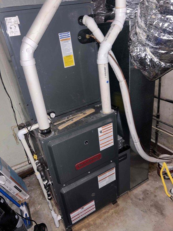 Performed an A/C diagnostic evaluation on the vertically stacked gas furnace and air handler system, inspecting the equipment cabinet, condensate piping, refrigerant line set, and associated flexible ductwork. Reviewed thermostat operation and system settings, and investigated reported moisture staining along the hallway, noting that previously suspected duct leakage may be contributing to moisture and microbial concerns. Findings and recommendations were documented for follow-up.
