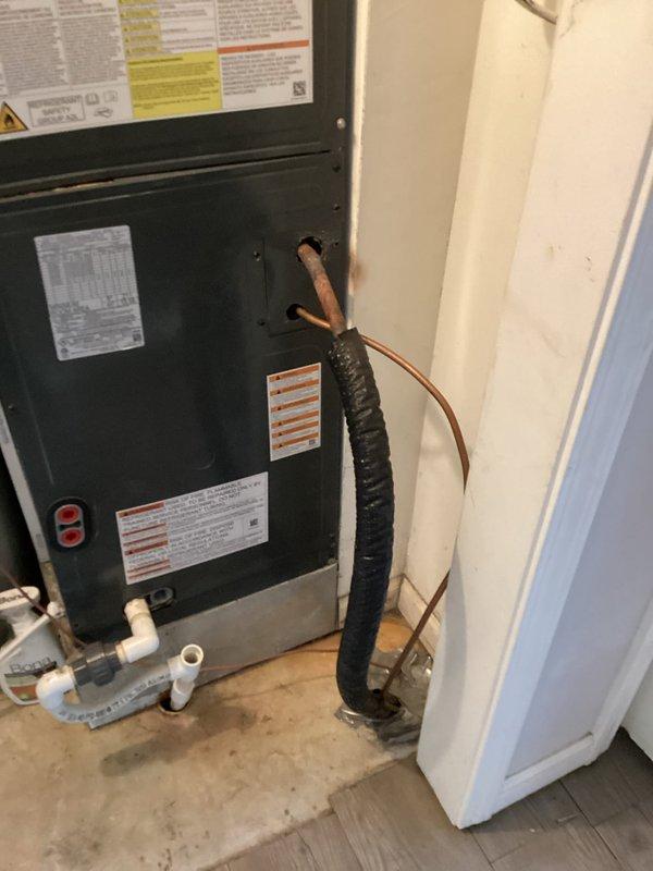 Performed A/C diagnostic evaluation on the system, confirming reported issues including a continuously running blower, a line set requiring reset, no emergency shut-off switch installed, and no filter present at the air handler. Inspected the Honeywell thermostat (displaying an alert with no Wi-Fi connectivity) and documented the air handler's condition, noting insulated suction line wear, rust staining at the line set penetration, and staining and moisture near the condensate drain piping. Findings were recorded with photos to support repair estimates, and a follow-up visit is recommended to quote corrective repairs.