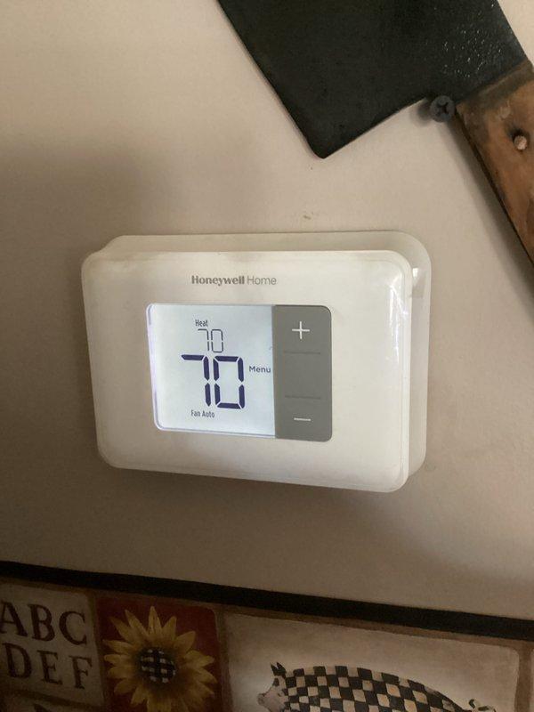 Performed a seasonal HVAC tune-up and system inspection, verifying thermostat operation in heat mode with the fan set to auto and calling for the setpoint of 70°F. Inspected the return-side filter housing, removed the dirty filter, and installed a new pleated filter, marking the install date on the frame. Confirmed the duct seams and retaining bracket were secure with sealant intact, and the system was left operating normally.