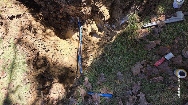 Excavated the affected section of the residential water service line, exposing the blue polyethylene pipe and removing the damaged segment. Installed new pipe with appropriate fittings, restoring a watertight connection to the home. Backfilled the trench and cleaned up the work area.