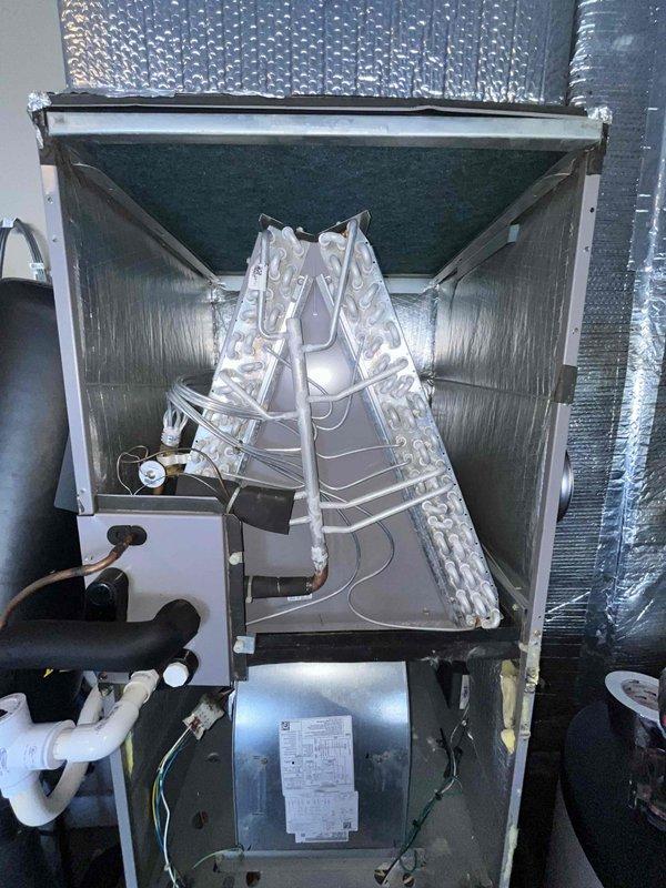 Performed annual heating maintenance inspection on the air handler, including inspection of the blower assembly, evaporator coil compartment, condensate drain piping, refrigerant line insulation, and ductwork connections, and serviced the washable filter. Noted light frost or moisture residue on the evaporator coil and refrigerant lines along with a slight lean in the coil, and recommended further evaluation of refrigerant charge and airflow. No rust or damage observed on the unit, and the system is operating normally for heating.