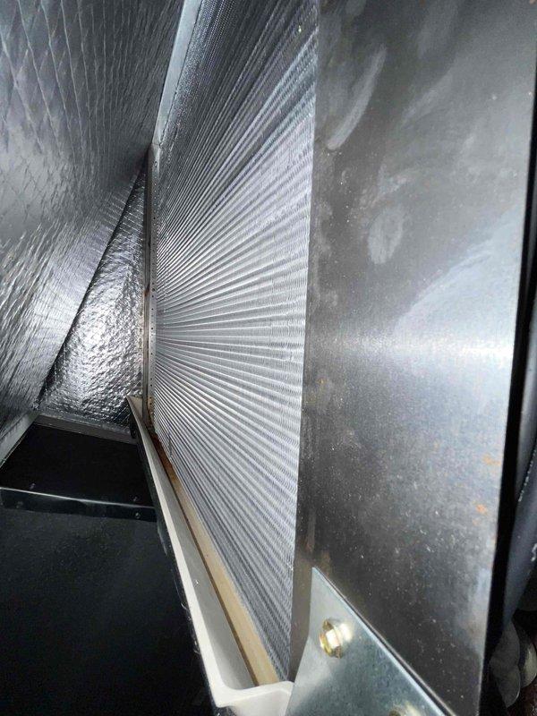 Performed a basic heating maintenance inspection of the air handler, including evaporator coil, drain pan, and blower assembly. The coil fins were clean with no frost or ice, the drain pan was intact, and the blower wheel was clean with no cracks, rust, or damage. Minor surface rust was noted on a cabinet panel near a galvanized bracket and should be monitored; the 20x20x4 filter was not included with this service.