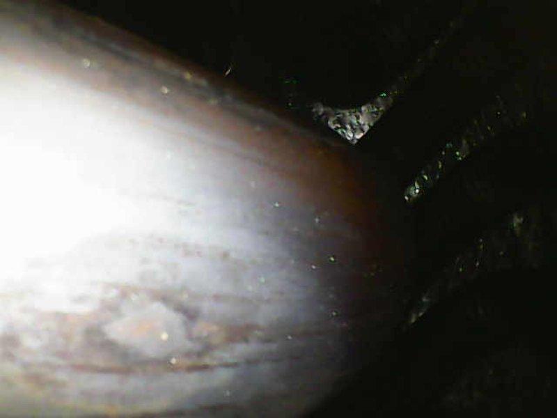 Responded to callback for recurring system error codes. Performed borescope inspection of the refrigerant line and evaporator coil, which revealed dust and grime buildup on the coil fins along with surface corrosion and staining on the tubing, restricting airflow and heat transfer. Cleaned the affected components and verified proper system operation, with error codes cleared.