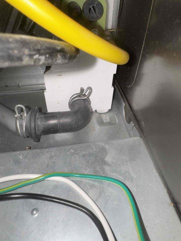 Performed annual maintenance inspection on the unit, including a visual check of the condensate drain piping, cabinet interior, and internal electrical wiring. Documented wet floor conditions and residue at the PVC drain joints, indicating possible condensate leakage, and recommend further evaluation of the drain line connections. Verified hose clamps and fittings were secure and noted loose internal wiring for follow-up.