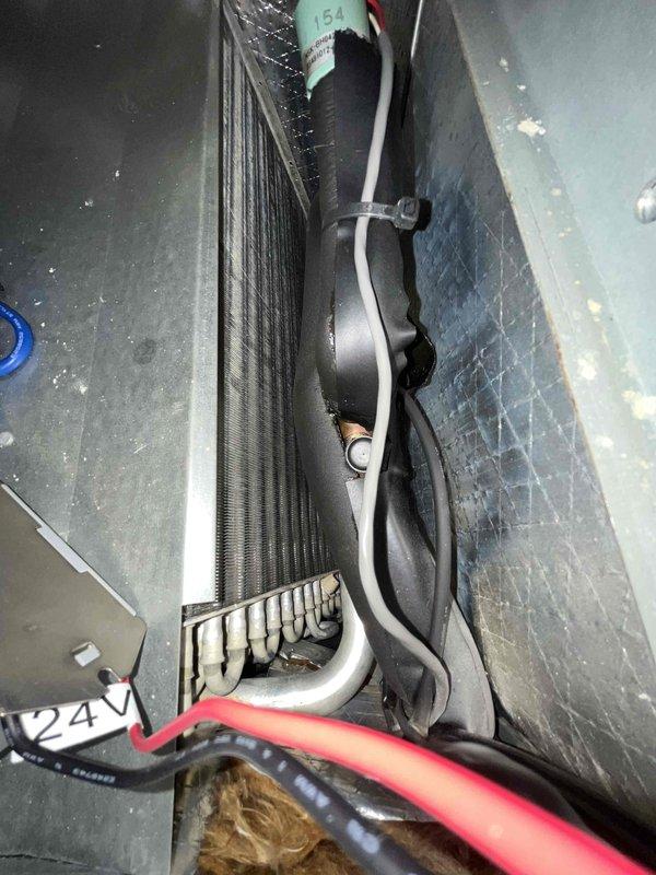Performed a monthly heating maintenance inspection on the air handler, including examination of the blower assembly, evaporator coil, and associated wiring. Observed light dust and grime accumulation on the blower wheel blades and minor surface discoloration on the motor shaft, and noted a split in the suction line insulation exposing a short section of bare copper tubing that should be re-insulated to prevent condensation. The 20x20x4 air filter was not included in this service.