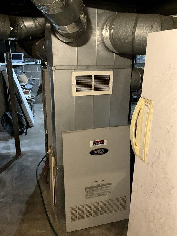Performed an on-site evaluation of a non-operational upright furnace and associated galvanized ductwork in a basement mechanical space to scope a full system replacement. Inspected the furnace cabinet, access panel, and supply/return duct runs, including flexible duct and taped duct joints, and documented existing conditions with photos. Prepared a replacement estimate for the failed unit, with scheduling coordinated to accommodate the customer's availability.