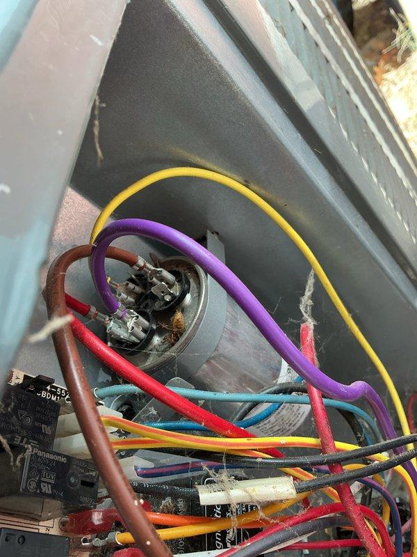 Performed seasonal heating maintenance on the HVAC system, inspecting the air handler and condensing unit components and removing accumulated dust and debris from the blower wheel and housing. Inspected the run capacitor and surrounding wiring, noting corrosion and debris at the terminals and cobweb buildup within the cabinet, and cleared the debris. Filter replacement was not included in this visit.