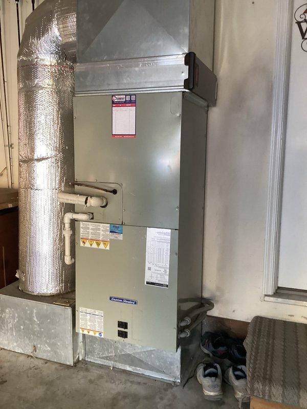 Performed heating-season preventive maintenance on the American Standard vertical air handler, inspecting the cabinet, supply plenum, insulated ductwork, condensate drain piping, refrigerant line connection, and electrical conduit, with no signs of frost, rust, or damage observed. Inspected the 20x25x4 media filter and documented its condition with the service date marked on the filter. The system was left in good operating condition.