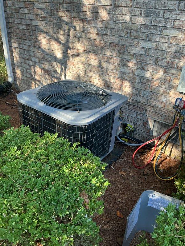 Performed Comfort Care maintenance on both the heating and cooling systems. On the outdoor condensing unit, removed the access panel, connected a manifold gauge set to check refrigerant system operating pressures, and inspected the condenser coil, fan assembly, and unit pad, finding no frost, ice, or rust. On the gas furnace, removed the lower access panel to inspect the burner assembly, inducer/blower motor, wiring, and controls, and checked the condensate drain trap and PVC piping, with no visible damage or deficiencies noted.