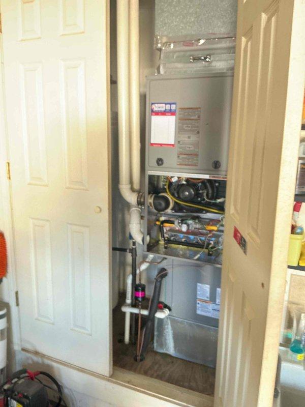 Performed Comfort Care maintenance on both the heating and cooling systems. On the outdoor condensing unit, removed the access panel, connected a manifold gauge set to check refrigerant system operating pressures, and inspected the condenser coil, fan assembly, and unit pad, finding no frost, ice, or rust. On the gas furnace, removed the lower access panel to inspect the burner assembly, inducer/blower motor, wiring, and controls, and checked the condensate drain trap and PVC piping, with no visible damage or deficiencies noted.