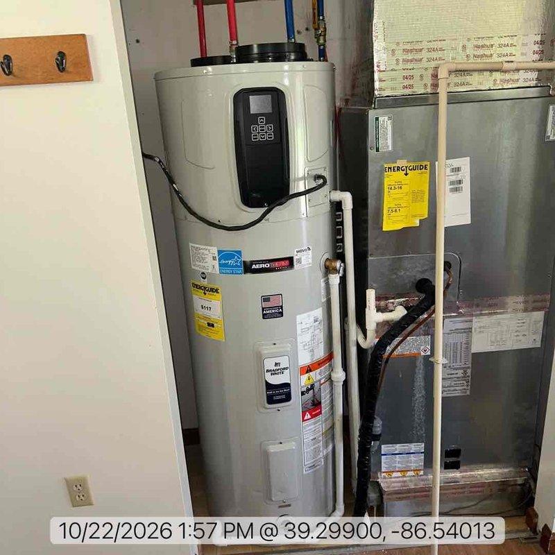 Installed a Bradford White AeroTherm heat pump water heater in a utility closet, connecting the hot and cold supply lines with flexible connectors, brass fittings, and a ball valve. Installed supply and return air ducting with collars on the unit and a louvered closet vent grille for adequate airflow, and ran the condensate drain line in PVC. Verified all connections were secure and leak-free with no visible damage.