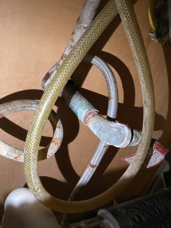 Diagnosed standing water at the front porch as a leak at the exterior hose bib, with moisture present at the spigot and damp soil below. Removed the corroded hose bib and the rusted, corroded supply connections and flexible lines, then installed new fittings and a replacement hose bib to restore a watertight seal. Pressure-tested the line and confirmed no further leakage or water pooling.
