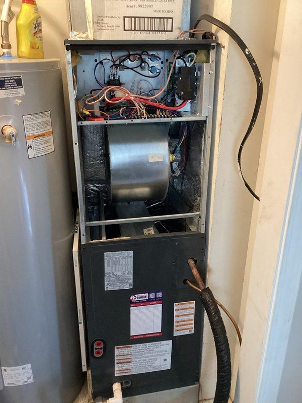 Inspected the vertical air handler following a prior repair and found the refrigerant line had been bent into position without a system pump-down, creating a risk of cracking the line. Also found a disconnect installed inside the cabinet that was difficult to access and unnecessary due to the nearby service breaker, along with disorganized low-voltage control wiring. Documented the unit condition and wiring, and noted the corrective work required to properly address the refrigerant line, wiring, and unneeded disconnect.