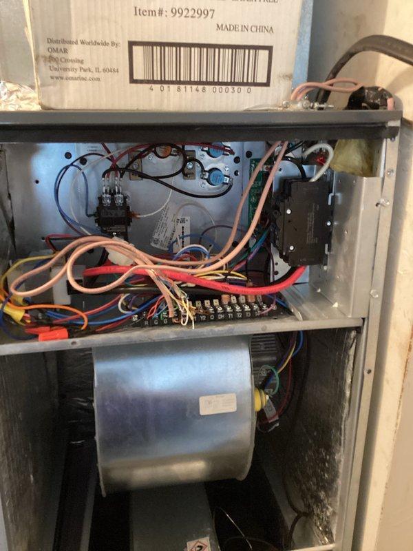 Inspected the vertical air handler following a prior repair and found the refrigerant line had been bent into position without a system pump-down, creating a risk of cracking the line. Also found a disconnect installed inside the cabinet that was difficult to access and unnecessary due to the nearby service breaker, along with disorganized low-voltage control wiring. Documented the unit condition and wiring, and noted the corrective work required to properly address the refrigerant line, wiring, and unneeded disconnect.