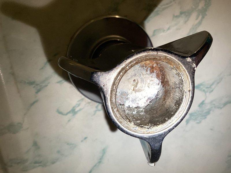 Diagnosed leaking fixtures at the kitchen sink, bathroom sink, and tub, and found heavy mineral scale and corrosion buildup in the tub faucet handle assembly, with worn, tarnished trim and a tape-repaired area on the tub surface. Evaluated the failed garbage disposal for replacement and assessed the installation requirements for the customer's newly ordered dishwasher.