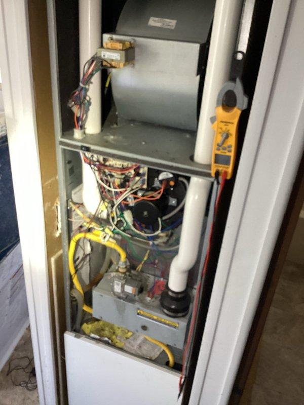 Responded to a no-operation complaint and verified the thermostat was functioning properly. Inspected the gas furnace, including the control board, 24V low-voltage circuit and fuse, transformer, and wiring connections, and performed electrical diagnostics with a clamp meter. Unit components showed no visible damage, frost, or corrosion.