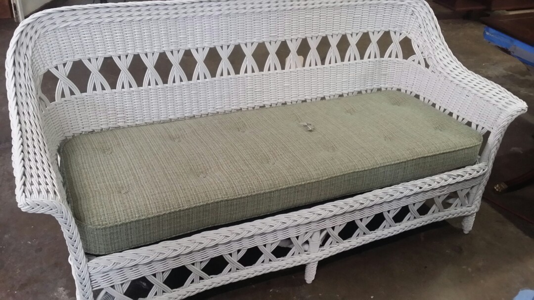 Wicker restoration of this old wicker couch and upholstery of a new cushion.