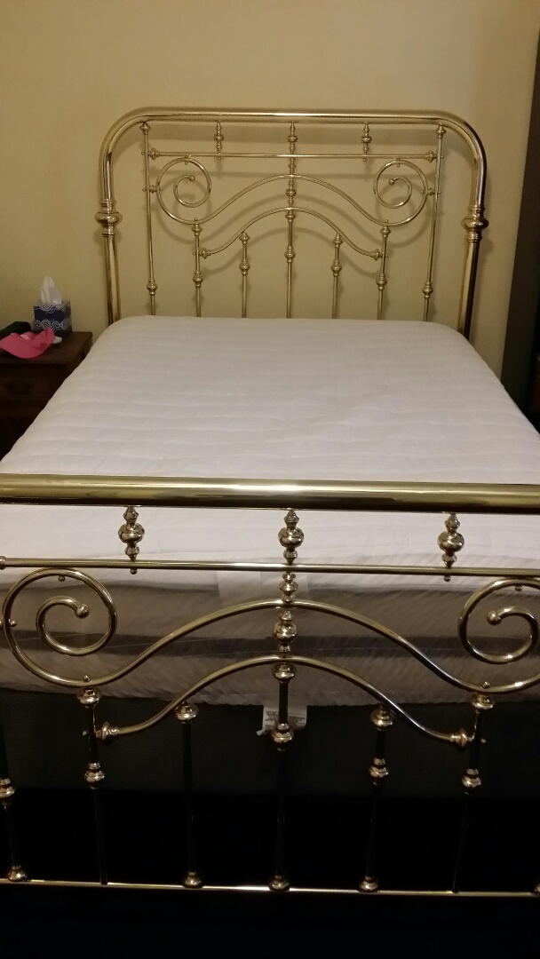 Polished brass bed