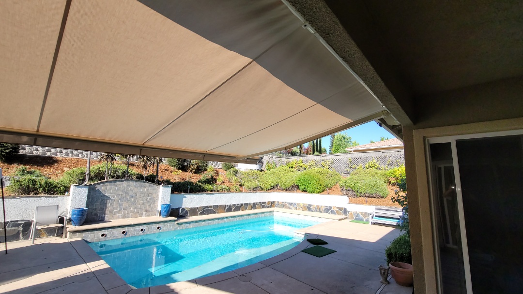 El Dorado Hills, CA - Installed a 18' wide x 10' projection, retractable awning, that the customer had purchased. It was on the north side of the house. Now during the hottest time of the rear, when the Sun is straight over head, the family can extend their awning to have that cool shade to better enjoy their swimming pool. Everyone loves shade! El Dorado Hills, CA - Installed a 18' wide x 10' projection, retractable awning, that the customer had purchased. It was on the north side of the house. Now during the hottest time of the rear, when the Sun is straight over head, the family can extend their awning to have that cool shade to better enjoy their swimming pool. Everyone loves shade!