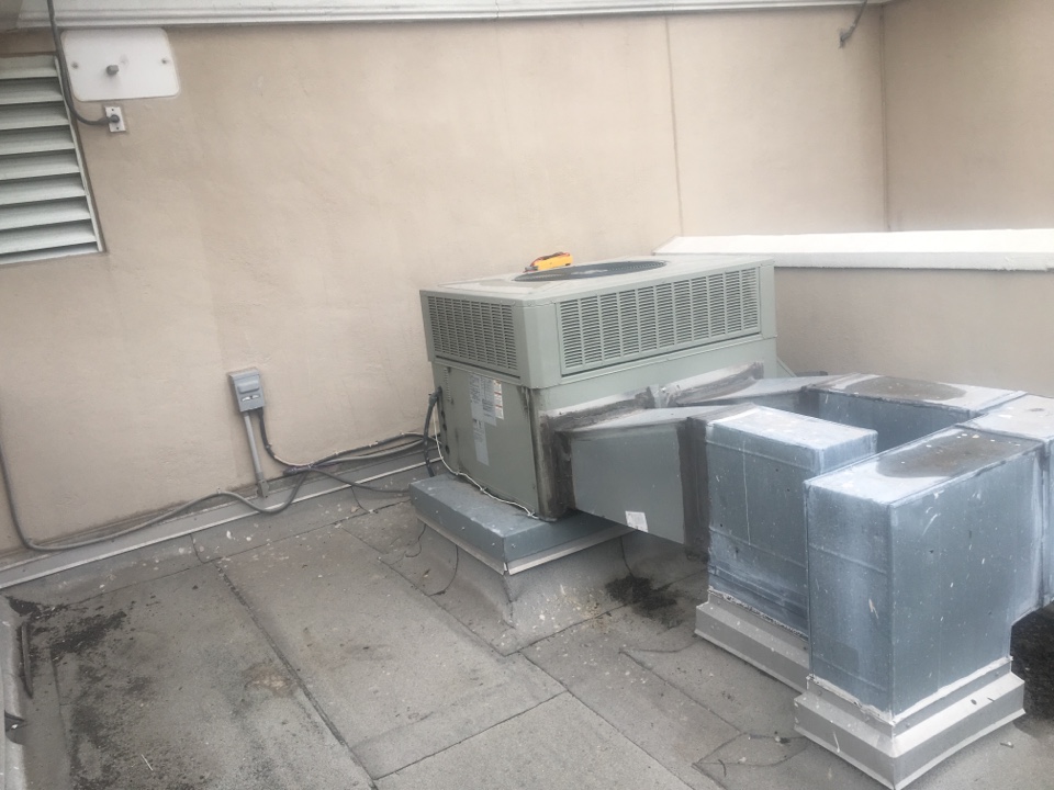 Working on Trane rooftop unit at Plaza Condominiums Bay St.