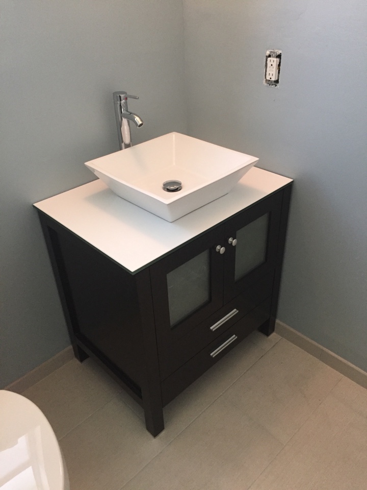 Install bathroom vanity and toilet