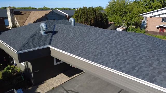 At this Saint Francis project, our crew performed a complete tear-off and re-decked the roof boards with fresh OSB to guarantee a level, long-lasting surface. We installed a durable CertainTeed NorthGate ClimateFlex Class 4 impact-resistant shingle system in Moiré Black, meticulously detailing around the home's existing feature elements—safely preserving three solar tubes and two B-vents with fresh ice and water shield seals. We finished the installation by adding new rear slant-back vents, pre-finished steel W-valleys, and custom re-pitched the existing seamless gutters using heavy-duty aluminum fascia brackets for reliable water runoff. We were happy to provide this property with a long-lasting and weather-ready roof. 