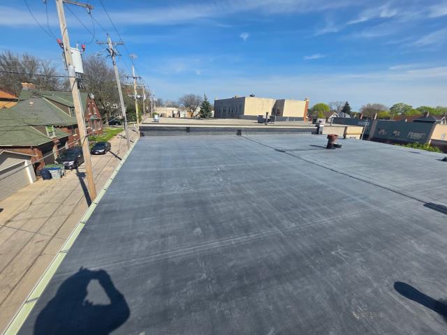 This Milwaukee project tackled complex commercial flat roof mechanics across both an upper and lower level! After stripping away the existing surface stone and old rubber EPDM down to the deck, we sheathed interior walls with fresh OSB and installed 1.5" insulation boards. To guarantee long-term stability against membrane shrinkage, we reinforced all wall intersections and HVAC curbs with RMS tape before fully adhering a heavy-duty 60mm EPDM rubber system using 20'x100' seamless rolls. We then upgraded the building's drainage capacity by expanding to oversized 4" retrofitted drains with tapered insulation saddles to eliminate standing water, custom-fabricated a 24-gauge steel edge apron with 6" cured rubber sealing, and anchored 40 feet of reglet-cut steel counter-flashing along the masonry block wall. We were happy to provide this local Milwaukee business with a long-lasting new roof!