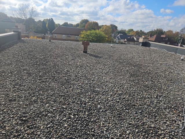 This Milwaukee project tackled complex commercial flat roof mechanics across both an upper and lower level! After stripping away the existing surface stone and old rubber EPDM down to the deck, we sheathed interior walls with fresh OSB and installed 1.5" insulation boards. To guarantee long-term stability against membrane shrinkage, we reinforced all wall intersections and HVAC curbs with RMS tape before fully adhering a heavy-duty 60mm EPDM rubber system using 20'x100' seamless rolls. We then upgraded the building's drainage capacity by expanding to oversized 4" retrofitted drains with tapered insulation saddles to eliminate standing water, custom-fabricated a 24-gauge steel edge apron with 6" cured rubber sealing, and anchored 40 feet of reglet-cut steel counter-flashing along the masonry block wall. We were happy to provide this local Milwaukee business with a long-lasting new roof!