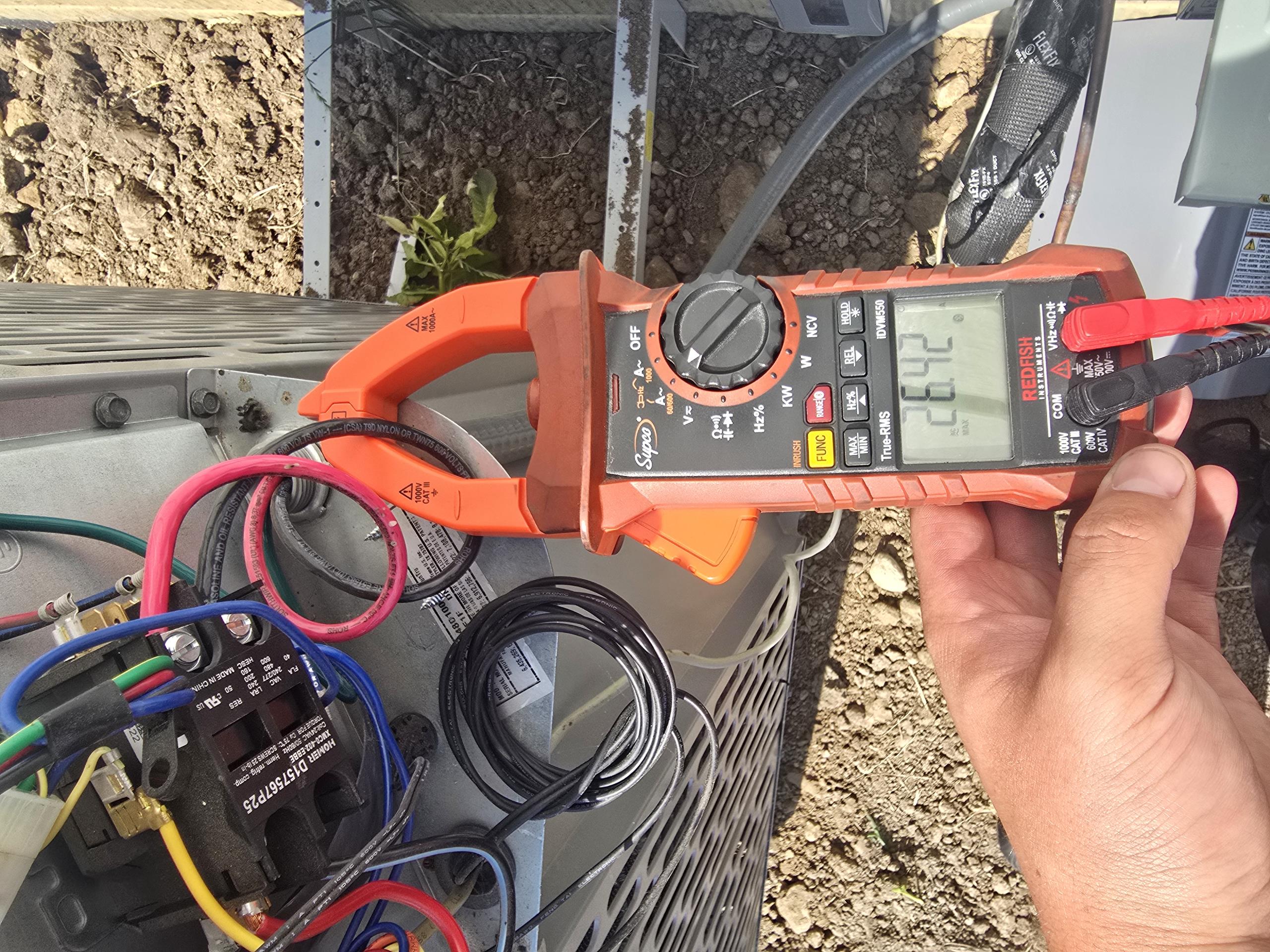 Did not find any issues that would cause a breaker to trip. Normal operation Amp draw is 11.4amps and startup Amp draw is 26.4 amps. Run capacitor is reading within spec. Stopped and started hnit multiple times to see if breaker would trip. Breaker did not trip while on site. Homeowner mentioned that electricians were there recently and checked for any loose connections and "cleaned the contactor contacts" but the contactor looks untouched due to dust on the contactor plastic housing not being disturbed. Homeowner said that the breaker has not tripped since the electricians were there. It is possible that if there were a problem, that the electrician may habe inadvertently fixed the issue while performing diagnostics or just tightening everything. 
Matt also asked about the thermostat possibly being in sunlight. Thermostat was not in sunlight while on site, and the closest window in the master bed was covered with closed blinds. Large windows in living room could possibly allow sun to Did not find any issues that would cause a breaker to trip. Normal operation Amp draw is 11.4amps and startup Amp draw is 26.4 amps. Run capacitor is reading within spec. Stopped and started hnit multiple times to see if breaker would trip. Breaker did not trip while on site. Homeowner mentioned that electricians were there recently and checked for any loose connections and "cleaned the contactor contacts" but the contactor looks untouched due to dust on the contactor plastic housing not being disturbed. Homeowner said that the breaker has not tripped since the electricians were there. It is possible that if there were a problem, that the electrician may habe inadvertently fixed the issue while performing diagnostics or just tightening everything. 
Matt also asked about the thermostat possibly being in sunlight. Thermostat was not in sunlight while on site, and the closest window in the master bed was covered with closed blinds. Large windows in living room could possibly allow sun to