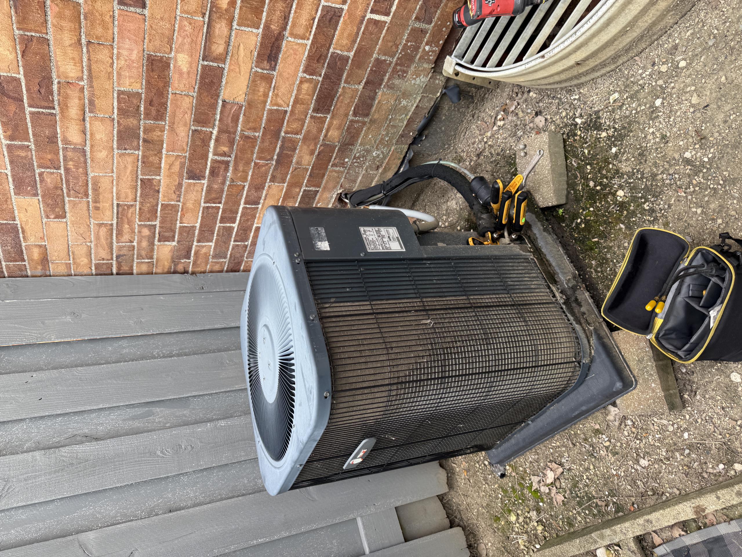 R22 system.  Low on refrigerant.  Blower and indoor coil are also plugged with dirt due to no proper filter rack.  Filter sitting inside the blower cabinet is not sufficient to keep the system clean.
Furnace is also old and in very poor shape.
Outdoor unit high voltage does not have a service disconnect.