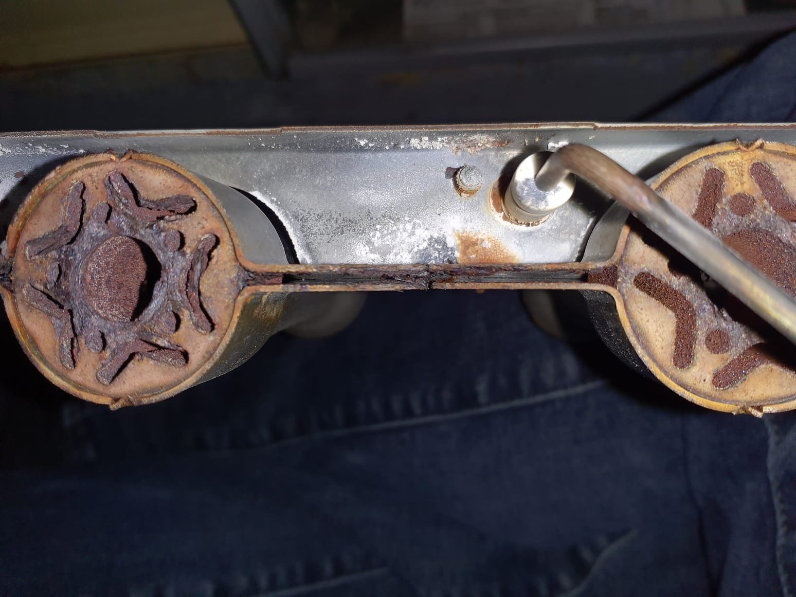 Upon arrival, thermostat is staisfied and system is not running. Performed a pre-operation inspection of the furnace that showed a clogged internal drain trap and rusty burners. These both contribute to operational issues as after longer periods of run time, the drain trap being clogged will cause the system to shut down due to internal flooding. Rusty burners contribute to starting procedure errors as the burns could not properly light, and/or a flame sense signal not being transmitted. Performed a test fire off to test hypothesis for rusty burner issues. During fire off, the first burner with the ignitor ignited immediately, while the other burners had a delayed ignition due to burner condition. Blow out drain trap to remove any clogged debris and confirmed proper drainage. Removed and wire brush cleaning of burners to clear out rust buildup in burner connection channels. 

Inspection also presented that the furnace and AC systems are both two stage while the current thermostat is on