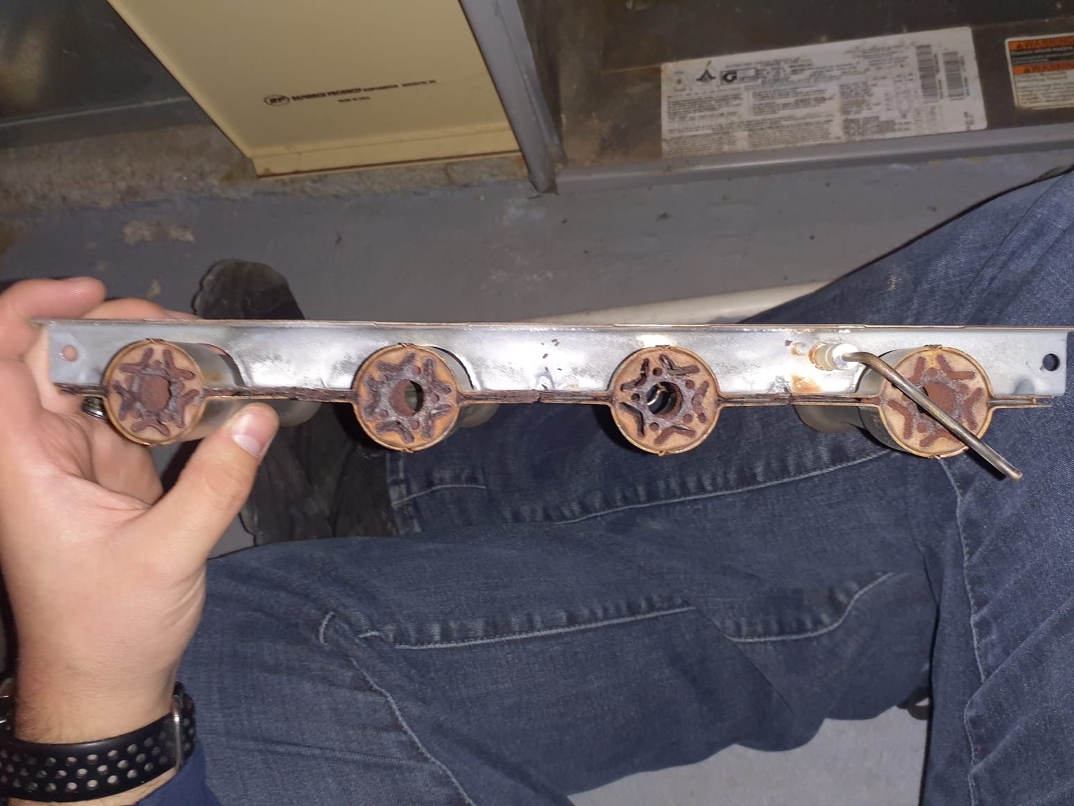 Upon arrival, thermostat is staisfied and system is not running. Performed a pre-operation inspection of the furnace that showed a clogged internal drain trap and rusty burners. These both contribute to operational issues as after longer periods of run time, the drain trap being clogged will cause the system to shut down due to internal flooding. Rusty burners contribute to starting procedure errors as the burns could not properly light, and/or a flame sense signal not being transmitted. Performed a test fire off to test hypothesis for rusty burner issues. During fire off, the first burner with the ignitor ignited immediately, while the other burners had a delayed ignition due to burner condition. Blow out drain trap to remove any clogged debris and confirmed proper drainage. Removed and wire brush cleaning of burners to clear out rust buildup in burner connection channels. 

Inspection also presented that the furnace and AC systems are both two stage while the current thermostat is on