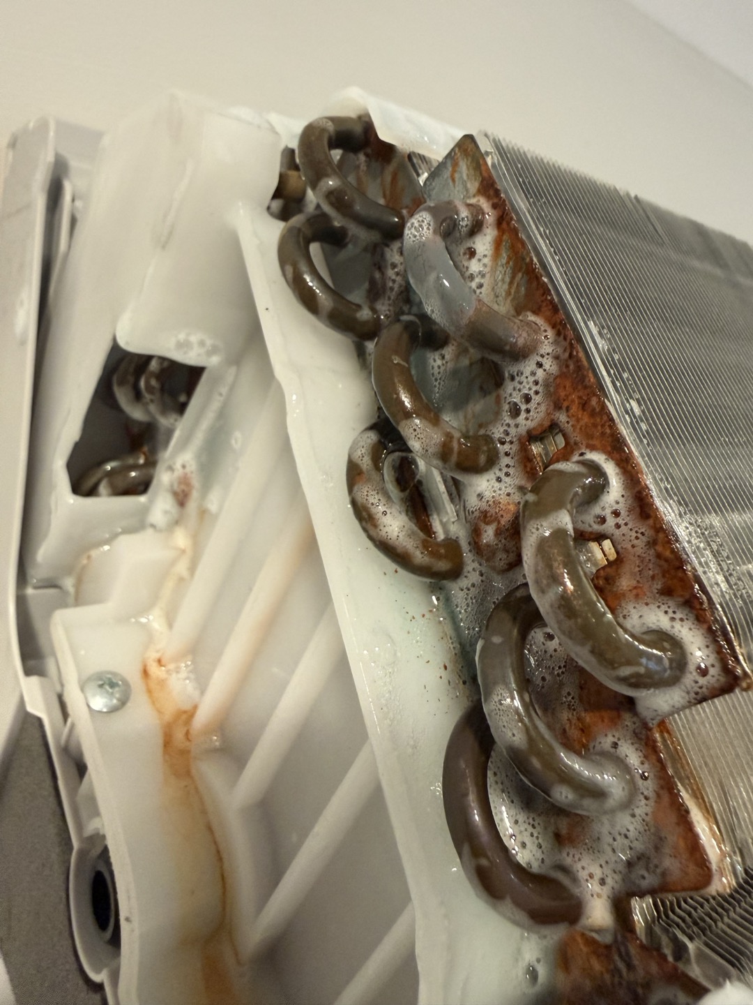 Upon arrival inspected unit and found no leaks outside. Tore down indoor head and found a leak on evap coil. Photo added of leak. Coil needs replaced under manufacturer warranty but labor and refrigerant is not covered.  