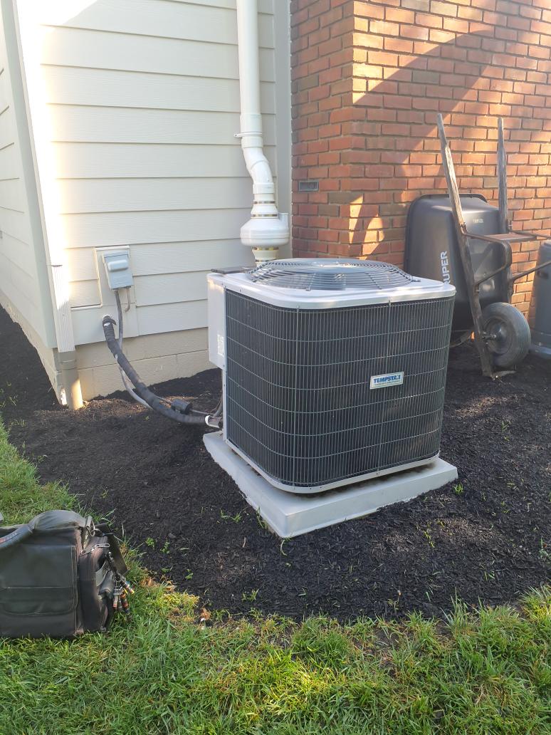 Upon arrival, Josh showed a video of the system operating while making the noise. Noticed in the video that thr fan motor was not operating. Checked 45/5 capacitor and found it reading 35/1. Capacitor being very low on spec caused the fan motor to not start. Replaced with new 45/5 Capacitor covered under parts warranty but no labor warranty. Test run operation to verify no other issues. System is operating properly at this time. Noise is most likely from high stress on compressor in not normal operating conditions, and/or internal pressure bypass opening due to no condensing fan motor operation.