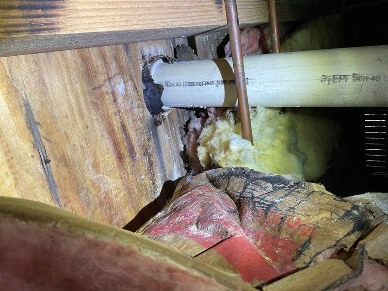Inspected and documented plumbing system components in attic crawl space, including PVC drainage lines, copper supply piping, and associated fittings and connections. Verified proper installation and current condition of pipe joints, insulation materials, and structural support elements within the confined utility space.