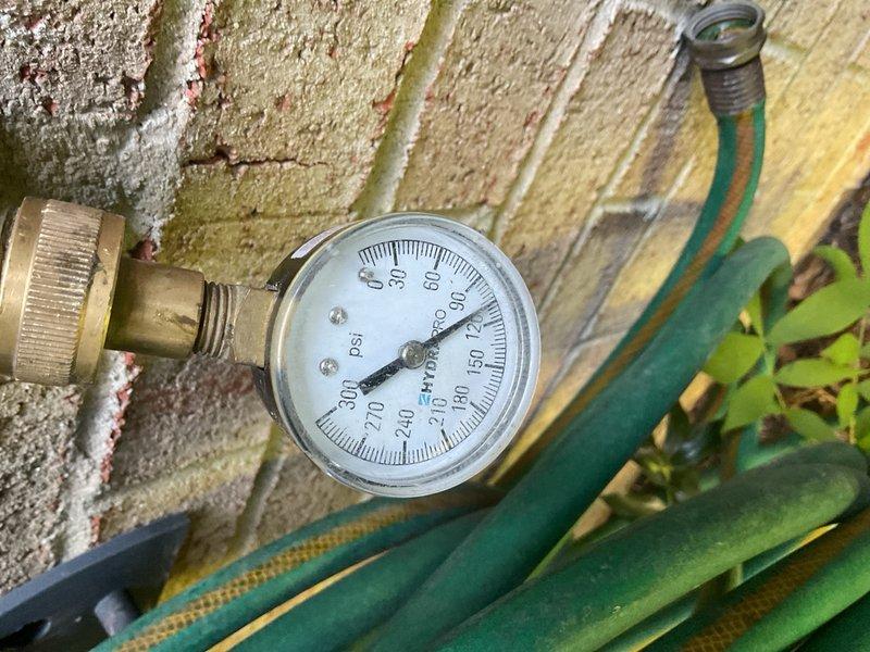 Performed irrigation system maintenance including replacement of deteriorated o-ring seals on the backflow preventer assembly. System pressure was tested and verified at proper operating range of 40-50 PSI following seal replacement to ensure leak-free operation and proper water flow to the irrigation zones.