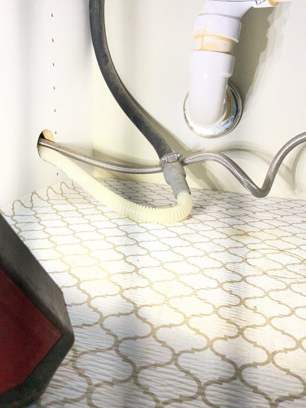 Plumber recommended under-sink plumbing repair including P-trap assembly, drainage components, water supply lines, and garbage disposal unit.