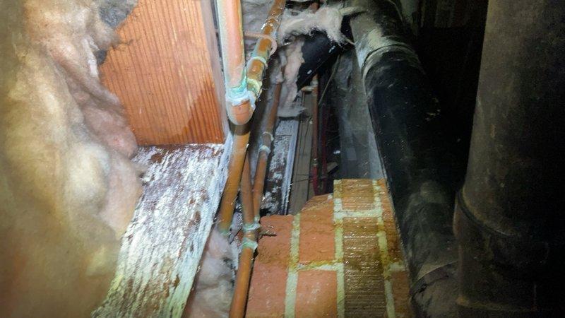 # New Estimate Completed

Conducted thorough assessment of crawl space and basement mechanical areas to evaluate existing HVAC infrastructure, plumbing systems, and structural conditions. Documentation included exposed fiberglass insulation showing age-related deterioration, copper piping with visible joints, horizontal ductwork with dust accumulation, and water-stained wooden joists indicating previous moisture intrusion. Identified blue PEX piping installation alongside older mechanical components beneath brick foundation surfaces requiring attention for proper system functionality and building envelope integrity.
