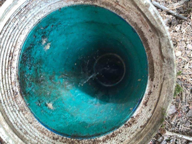 Completed inspection and documentation of drainage culvert system and HVAC infrastructure in confined utility space. Corrugated metal culvert pipe showed standing water accumulation with visible sediment deposits and corrosion at waterline, indicating potential drainage flow issues requiring monitoring. Interior HVAC space revealed aged ductwork system with compromised insulation materials, deteriorated vapor barriers exhibiting moisture staining, and accumulated debris throughout accessible areas, documenting current condition for maintenance planning and future remediation recommendations.