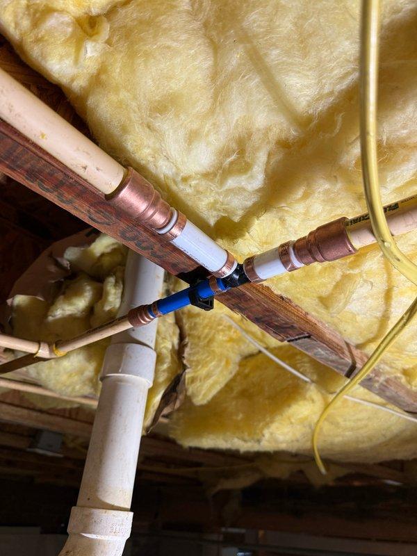 Performed plumbing inspection and maintenance in crawlspace area, accessing exposed piping systems between floor joists. Evaluated condition of copper supply lines and PVC drain pipes, checking for leaks, corrosion, and proper support. Cleaned and removed debris from work surfaces in the immediate area following completion of the inspection.