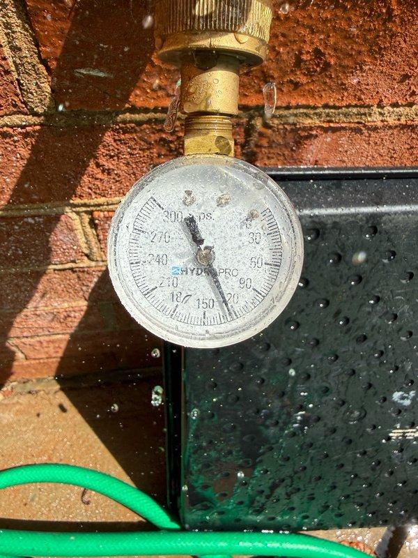 Performed pressure testing and inspection of HVAC system components. Monitored system pressure using calibrated gauge, which indicated proper zero reading at time of inspection. Removed and inspected pipe fitting, revealing significant mineral deposits and scale buildup on interior surfaces. Identified corrosion and sediment accumulation that could impact system performance and efficiency. Component showed evidence of oxidation and calcium deposits typical of extended water exposure in hydronic systems.