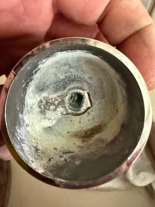 Performed pressure testing and inspection of HVAC system components. Monitored system pressure using calibrated gauge, which indicated proper zero reading at time of inspection. Removed and inspected pipe fitting, revealing significant mineral deposits and scale buildup on interior surfaces. Identified corrosion and sediment accumulation that could impact system performance and efficiency. Component showed evidence of oxidation and calcium deposits typical of extended water exposure in hydronic systems.
