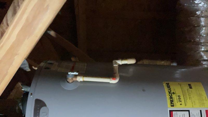 Performed inspection and documentation of water heater installation in attic space. Unit observed to be properly mounted on wooden support platform with appropriate copper piping connections at top of tank. Verified presence of required safety labels and EnergyGuide documentation affixed to exterior of tank. Documented existing installation conditions including proximity to ductwork, adequate clearances within attic framing, and accessibility for future maintenance requirements.