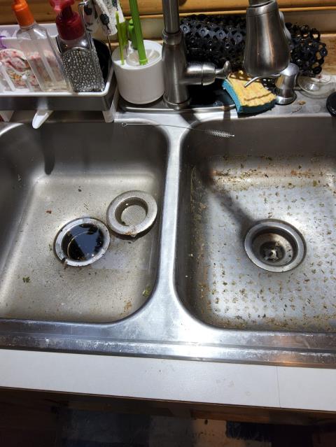 La Conner, WA - Lekaing kitchen sink with a clogged drain repair. Auger and repipe in progress. 